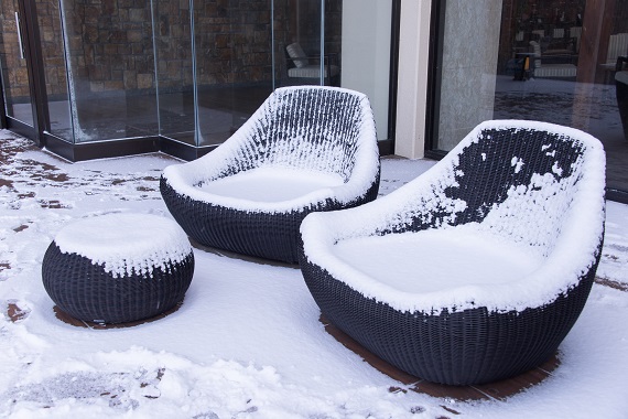 Snow covered chairs in garden