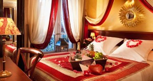 romantic-honeymoon-suite-bedroom-design-in-red-white-and-gold-color-with-beautiful-bed-set-with-red-heart-ornaments-and-decorative-bed-cover-plus-amazing-golden-sun-shaped-wall-decor-decorating-ideas